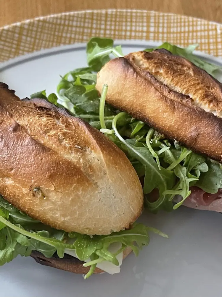 Crusty baguette filled with ham, cheese and rocket